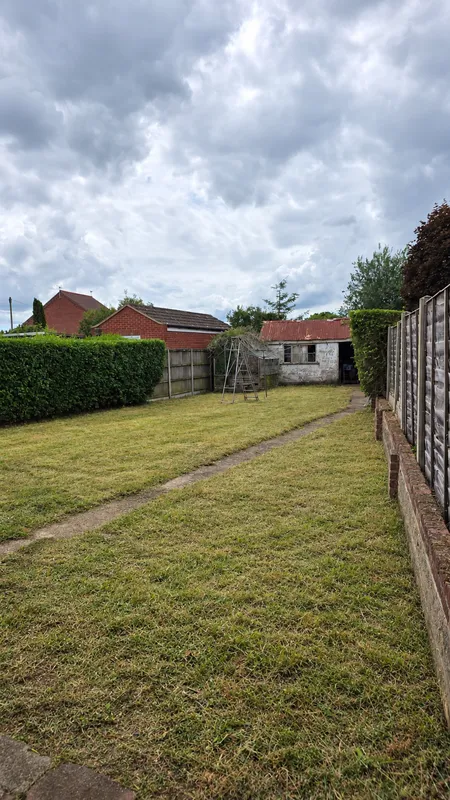 Large garden with cut lawn and visible path after GreenRun clearance